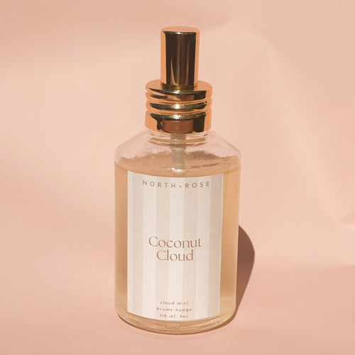 Perfume bottle labeled 'Coconut Cloud' by 'North+Rose' on a pink background