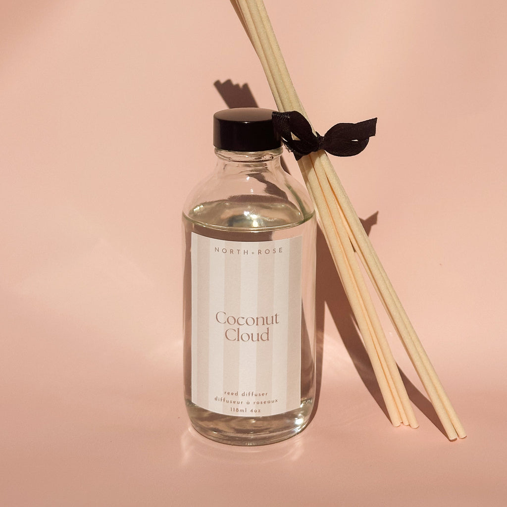 Reed diffuser with 'Coconut Cloud' label on a pink background