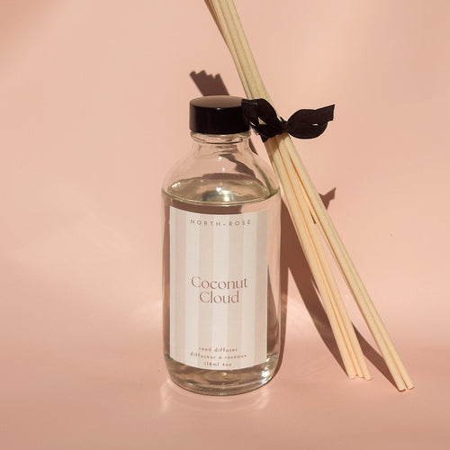 Reed diffuser with 'Coconut Cloud' label on a pink background
