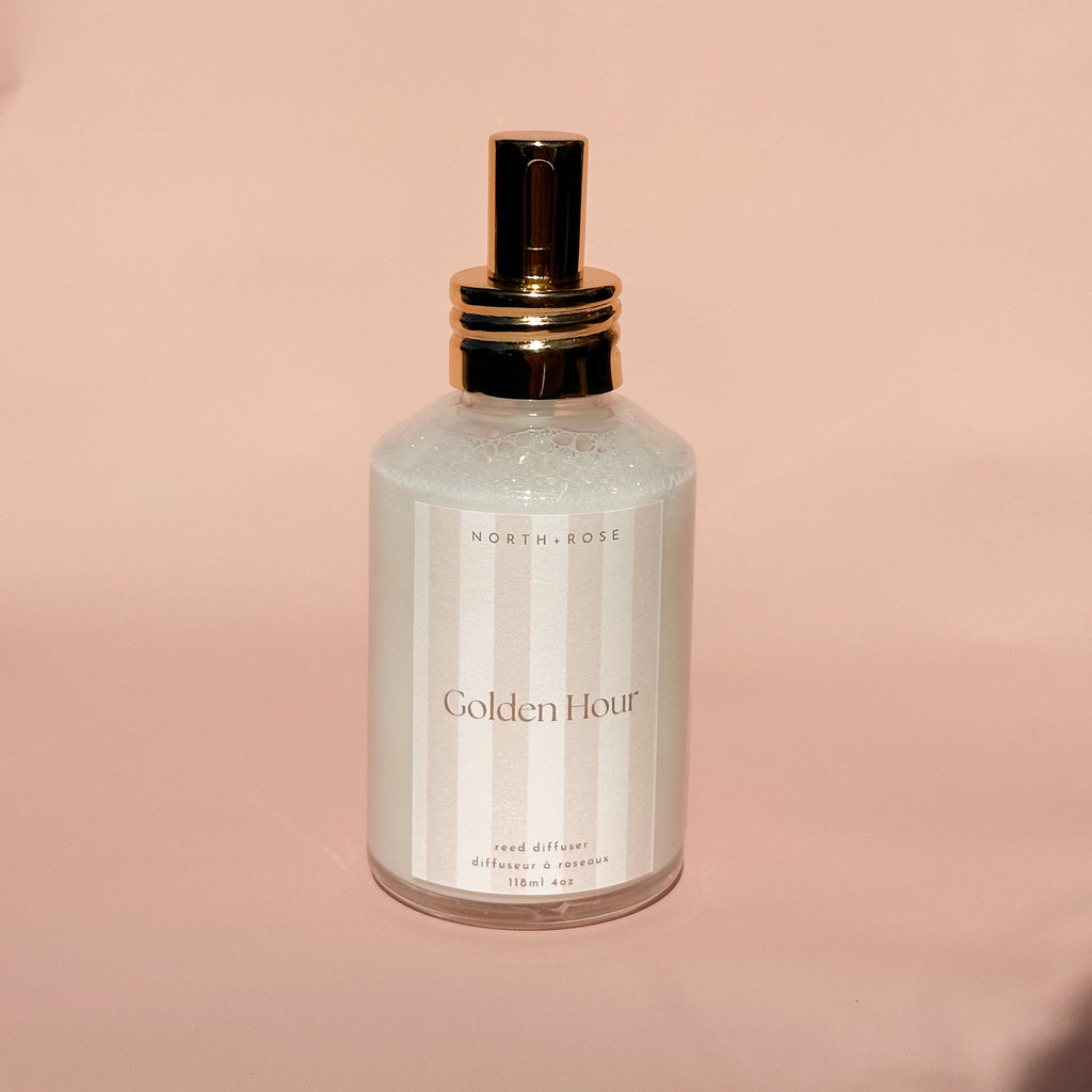 Skincare bottle labeled 'Golden Hour' on a pink background