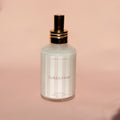 Skincare bottle labeled 'Golden Hour' on a pink background